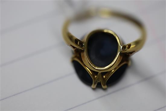 A 1920s 18ct gold, platinum and oval black opal dress ring with diamond set shoulders, size M.